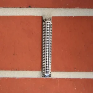 Red brick wall with a Weepa Protector Screen installed in weep hole