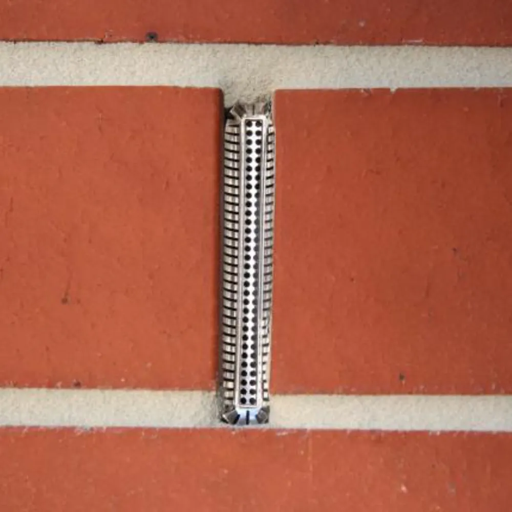 Weep hole covers installed in wall