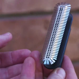 Hands holding a Weepa Protector weep hole screen with screen on applicator tool.